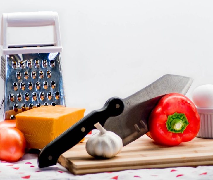 knife, tomatores, eggs, cheese, garlic and food grater