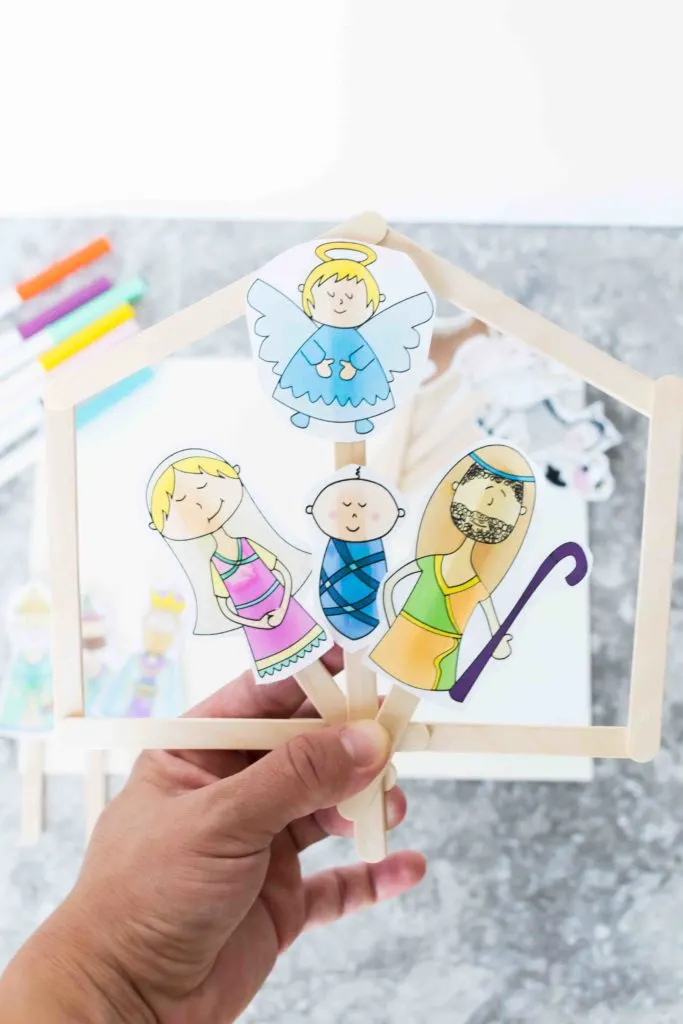 Holding up Baby Jesus, Mary, Joseph an Angel colored printable puppet sticks