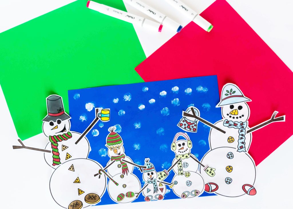 colored snowmen cut outs for coloring project displayed on construction paper
