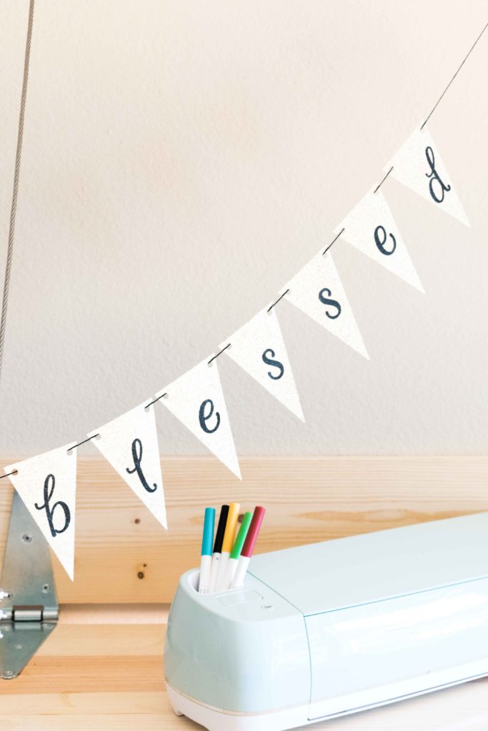 Displaying a triangular banner made with Cricut - The banner says blessed