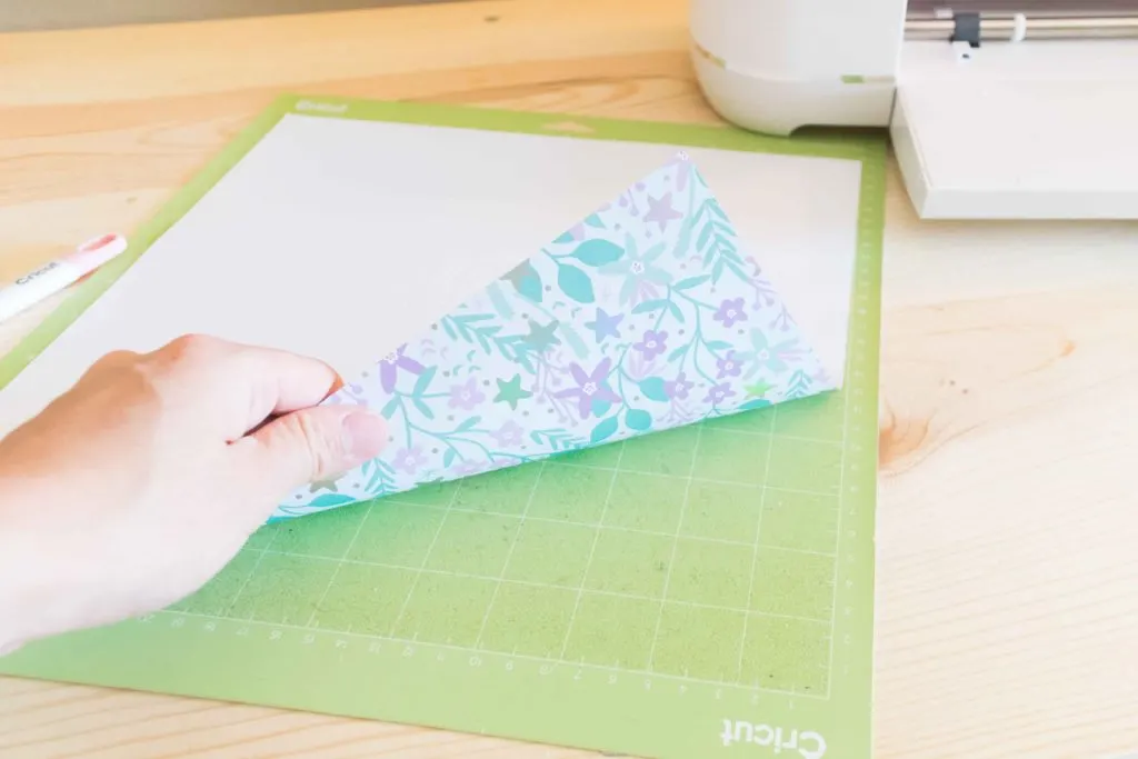 Placing Patterned paper pretty side down on Cricut Mat
