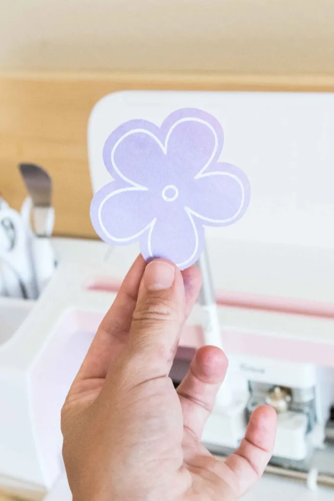 Holding a flowe cut and drawn with the Cricut Pens