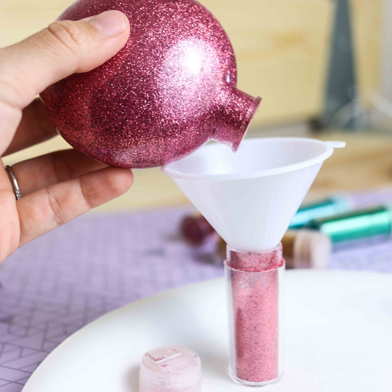Returning excess glitter inside of Christmas Ornament to original container