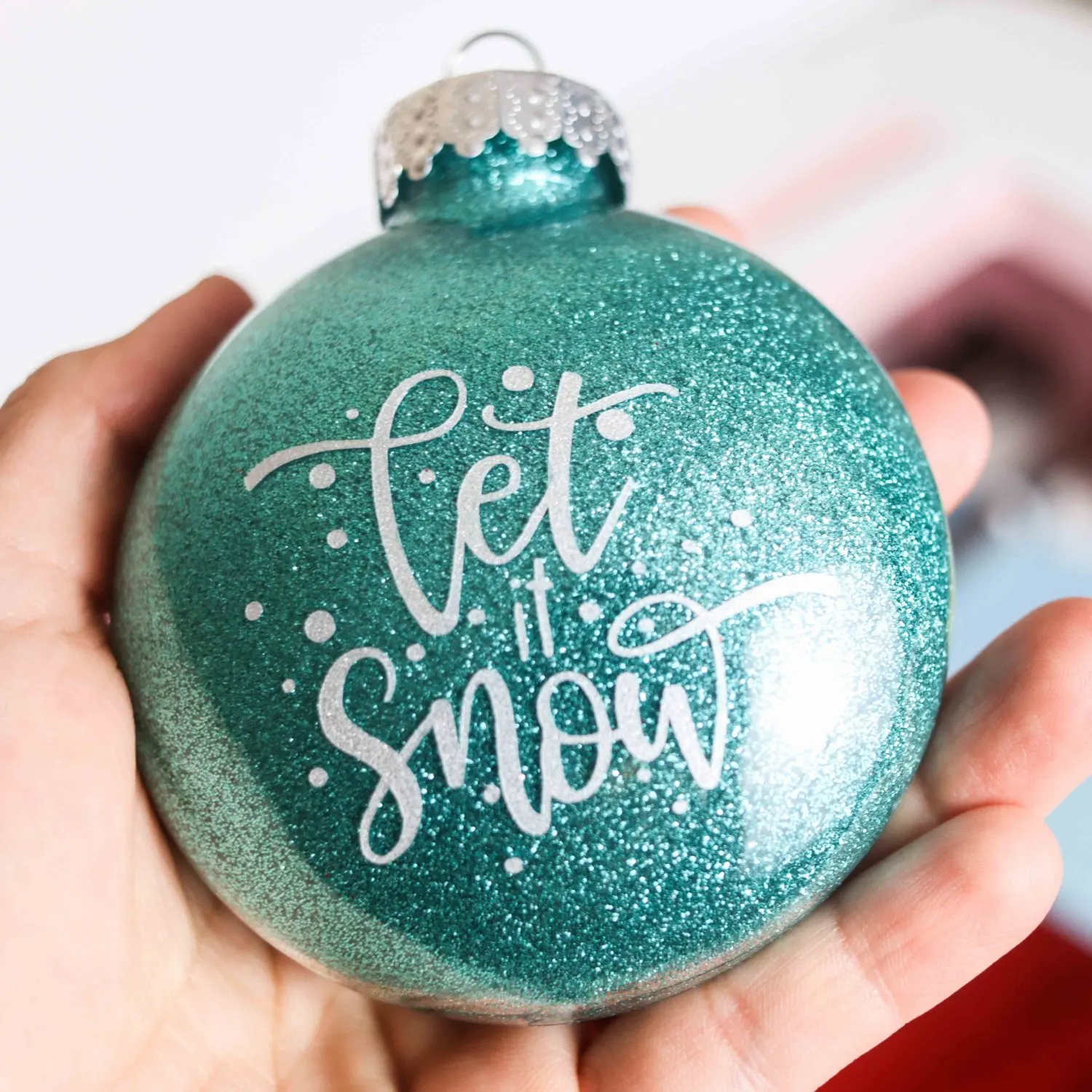 blue glitter Christmas Ornament with "let it snow" phrase