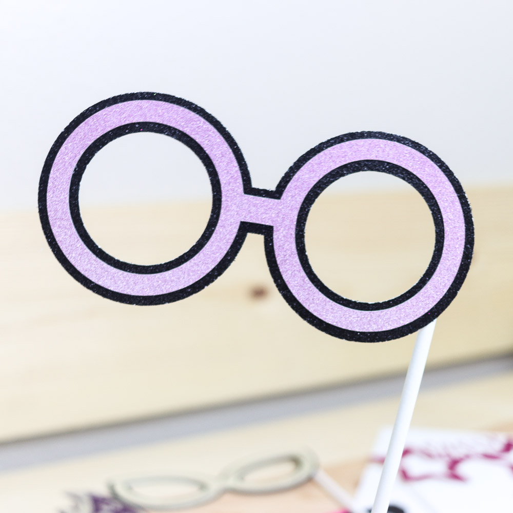 circle shaped glasses made with purple and black glitter carsdtock