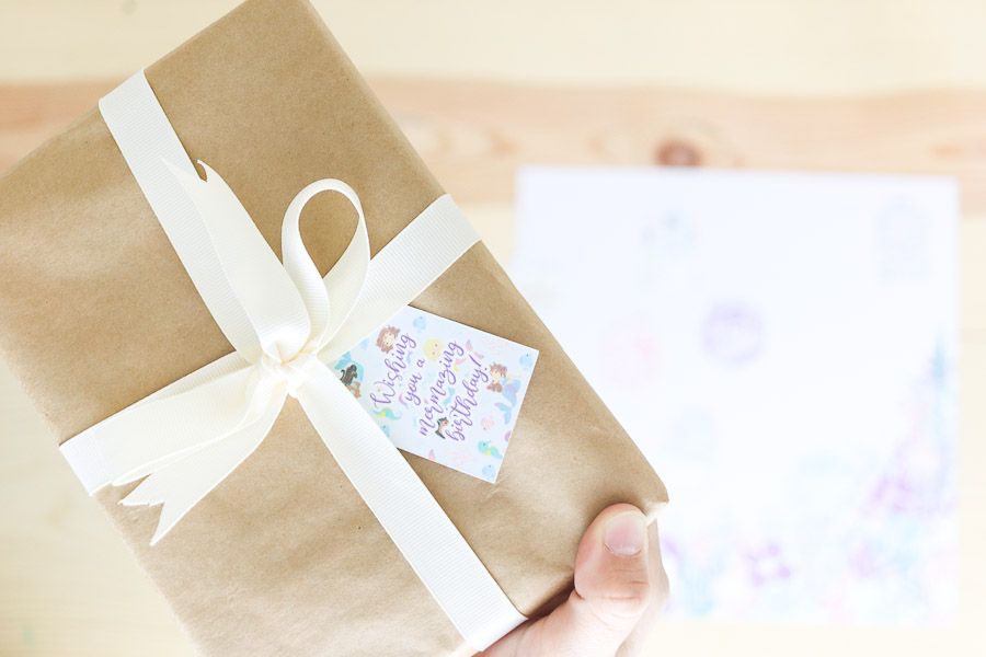 Small wrapped present with a mermaid birthday gift tag
