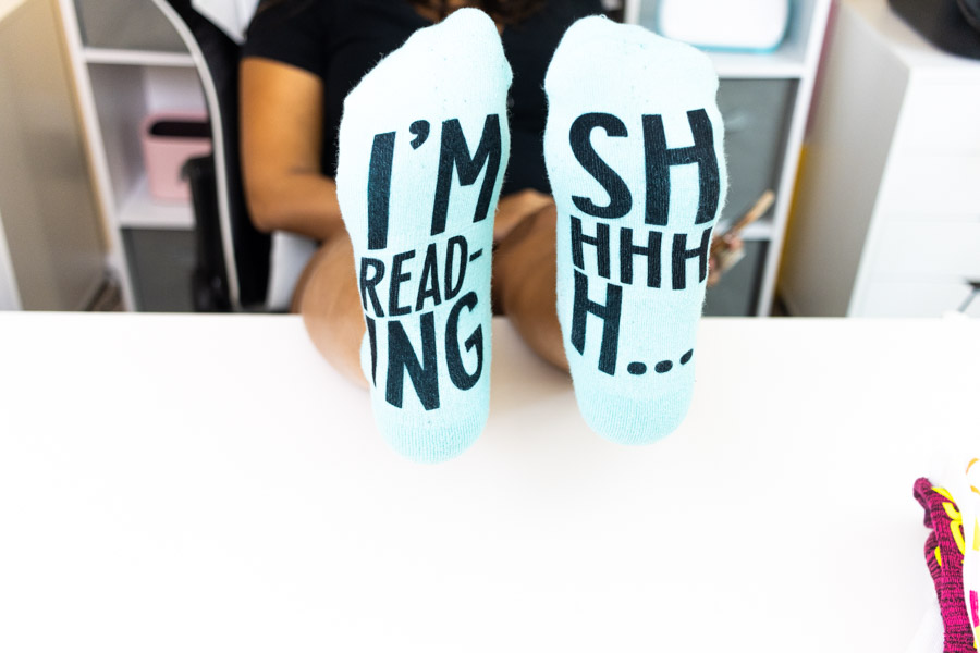 wearing pair of sock personalized with cricut infusible ink