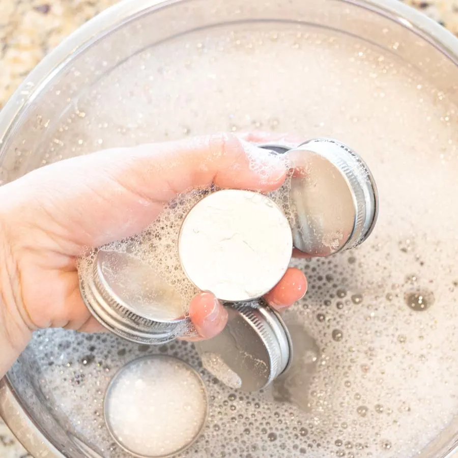 washing spice jar caps with soapy water