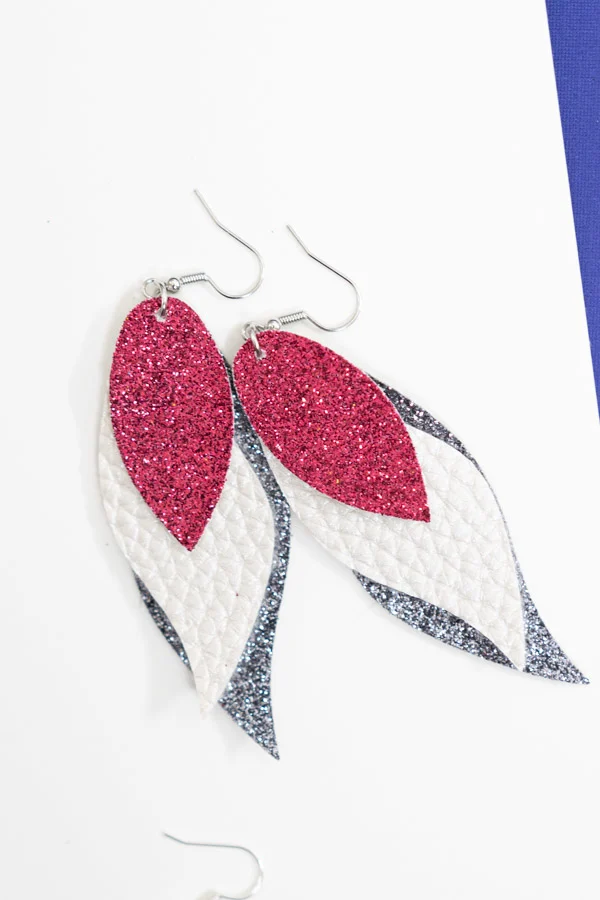 cricut earrings made with faux leather and glitter canvas.
