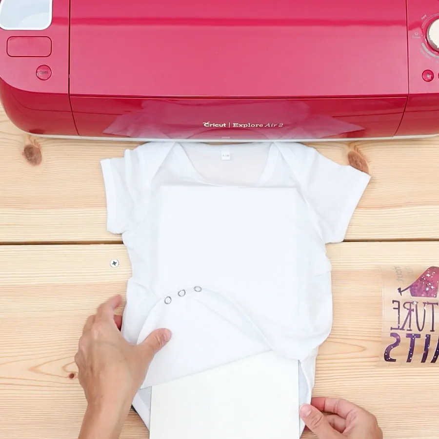 placing cardstock inside baby bodysuit