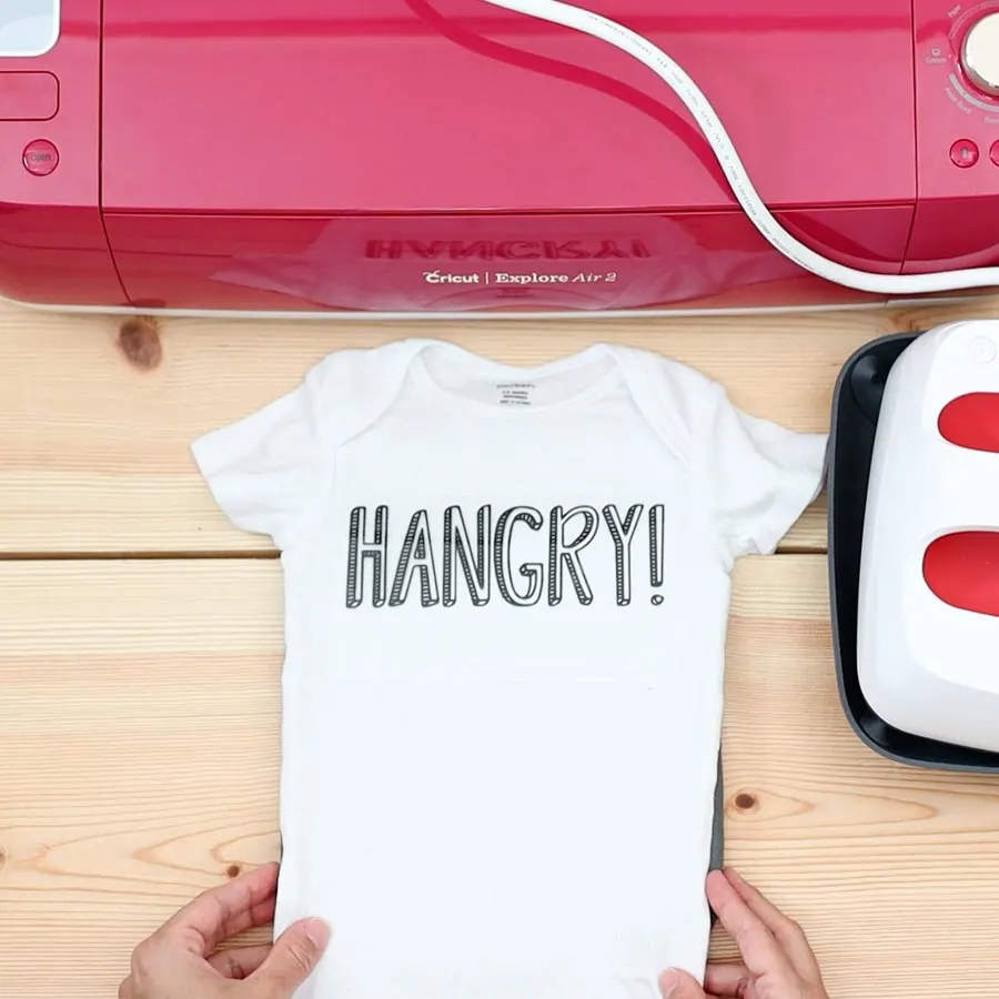 placing hangry design on baby onesie