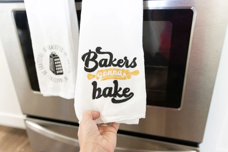 kitchen towel made with freezer paper stencils and cricut machine - bakers gonna bake