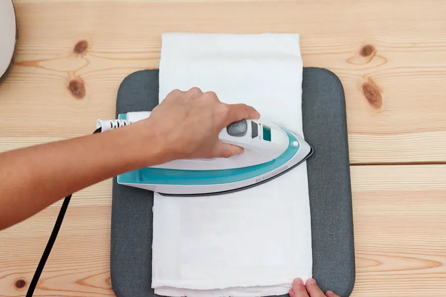 ironing freezer paper stencil on tea towel