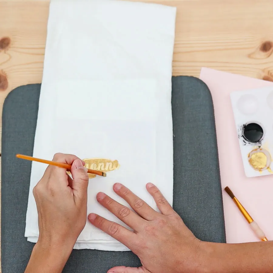 painting tea towel with gold pain and freezer paper stencil