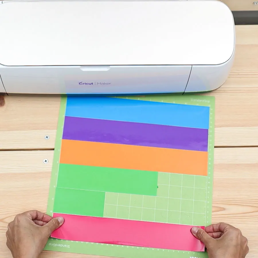 placing adhesive vinyl on mat to cut labels