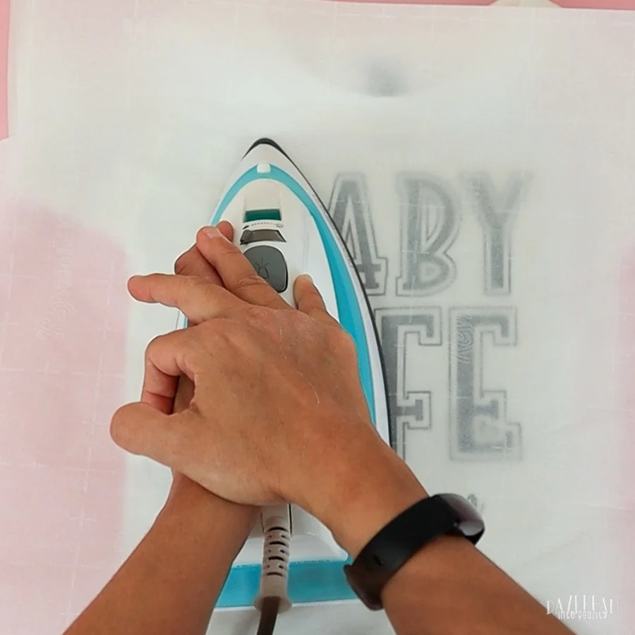 place parchment paper on top and press design onto t-shirt with an iron 2.
