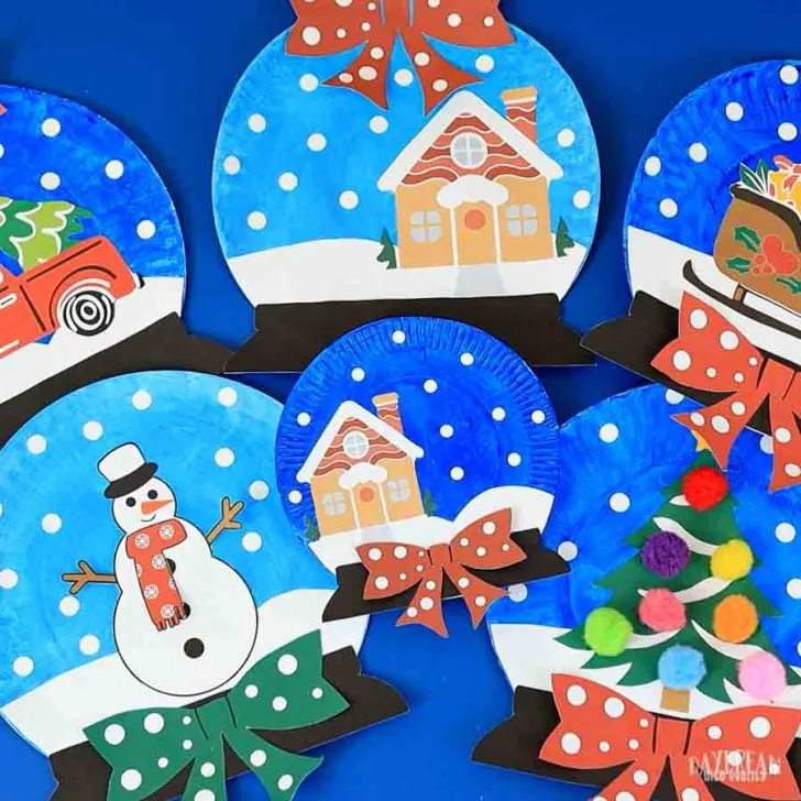Snow globe crafts made with paper plates, paint, bows, etc.