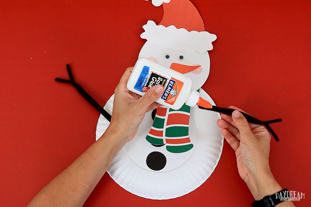 glue pipe cleaner arm to snowman