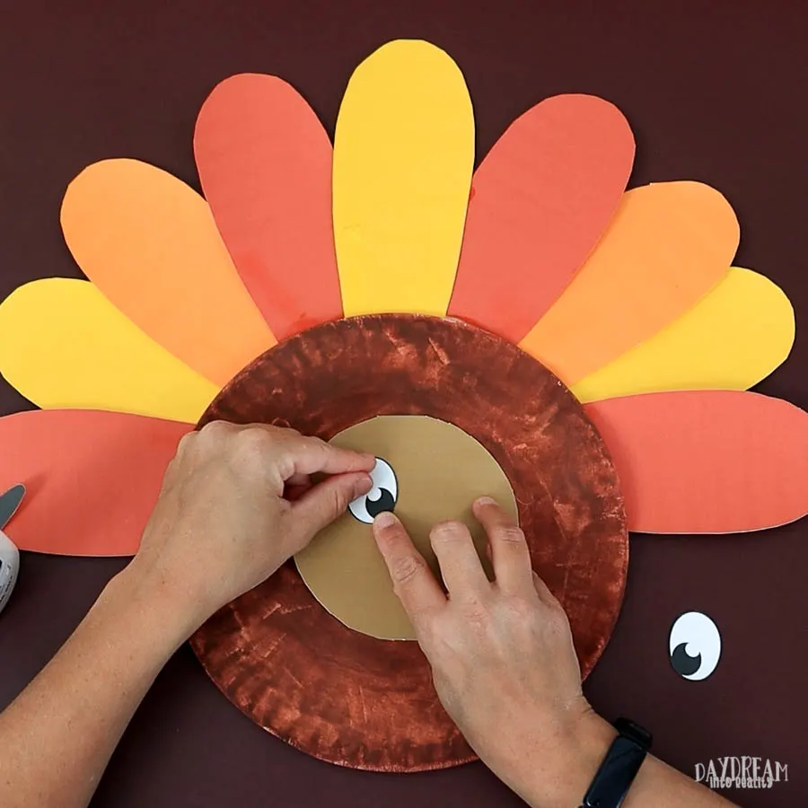 glue eyes paper plate turkey craft.