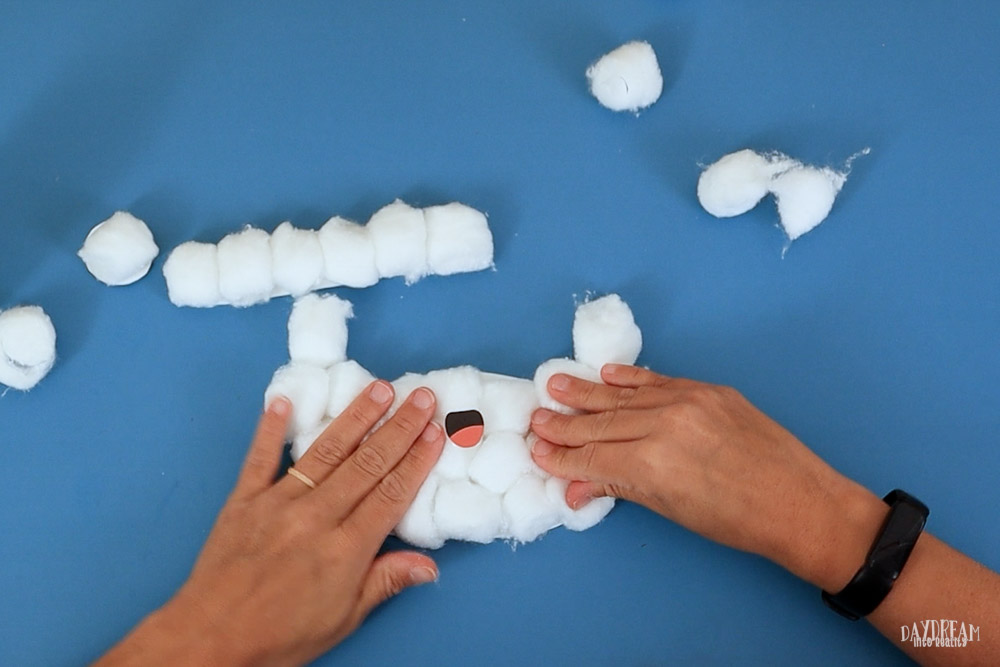 Glue cotton balls to Santa's beard and mouth on top.