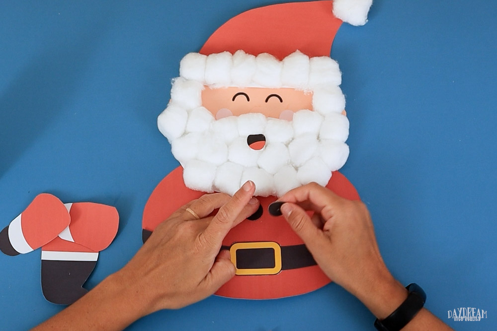 Glue buttons to Santa's body.