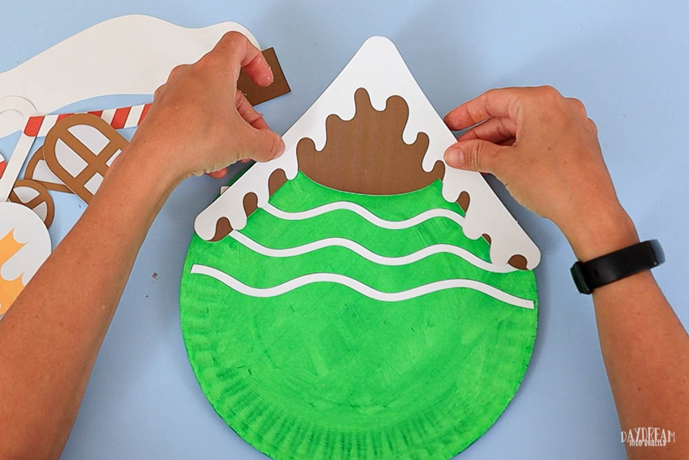 gluing roof on gingerbread house