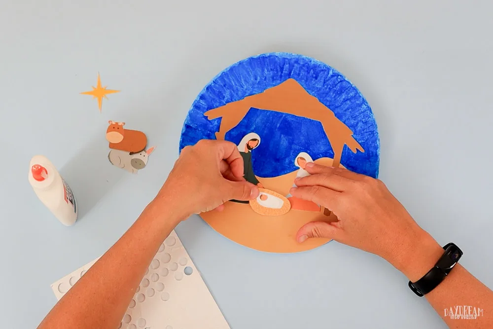 glue baby Jesus with foam dot to paper plate craft