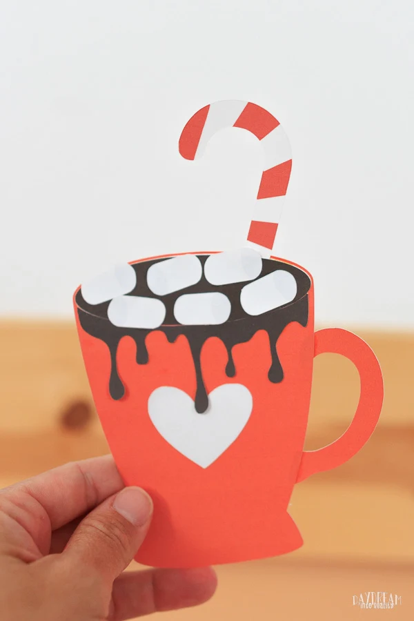 paper hot cocoa craft for kids - red mug with, candy cane, and marshmallows.