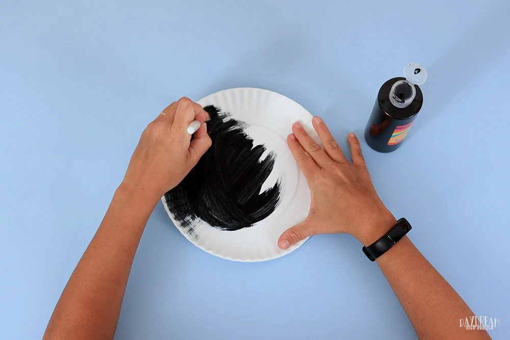 painting paper plate in black