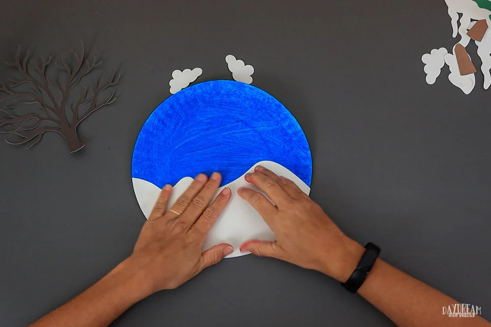 glue snow to paper plate